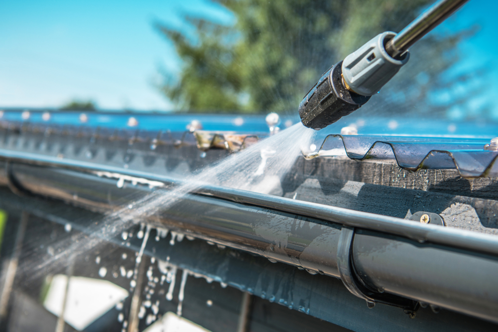 A gutter getting power washed