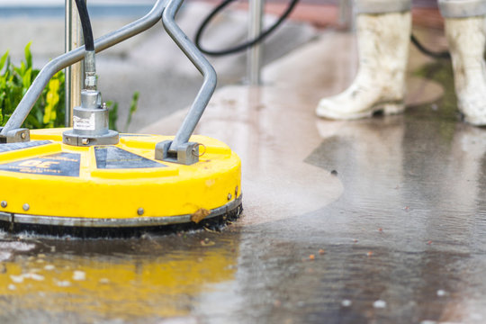 Surface cleaner being used on a sidewalk