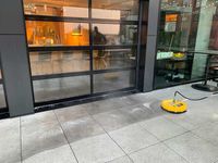 person power washing a driveway